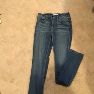 CrossFit Relentless medium wash jeans.